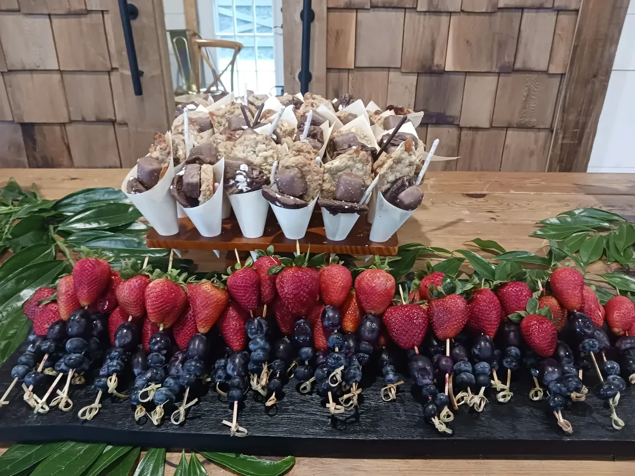 Berry skewers and chocolate dessert cones display