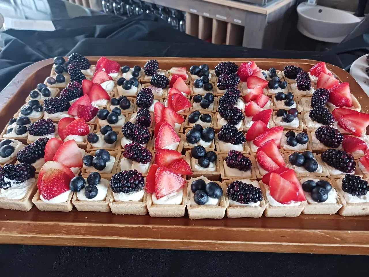 Mini berry tarts with cream and fresh berries