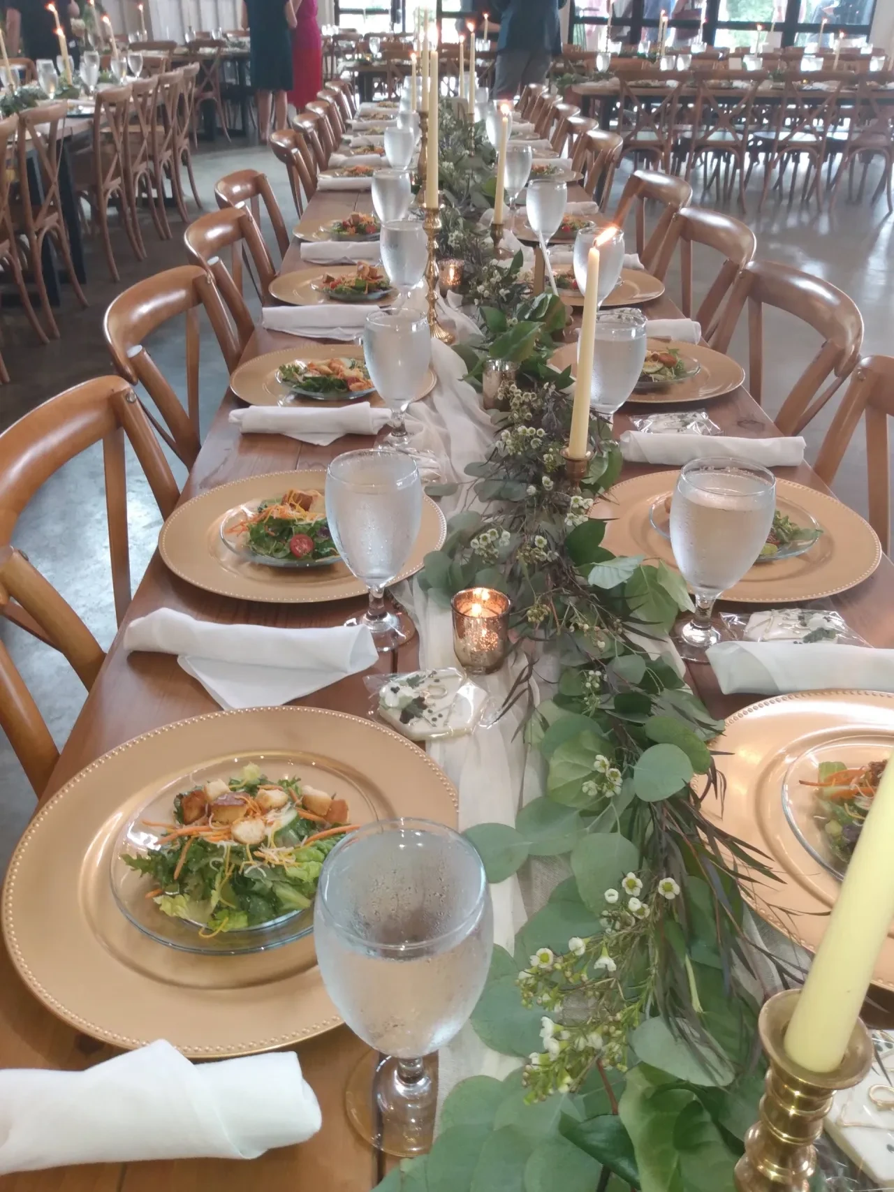 Elegant banquet table setting with greenery and candles