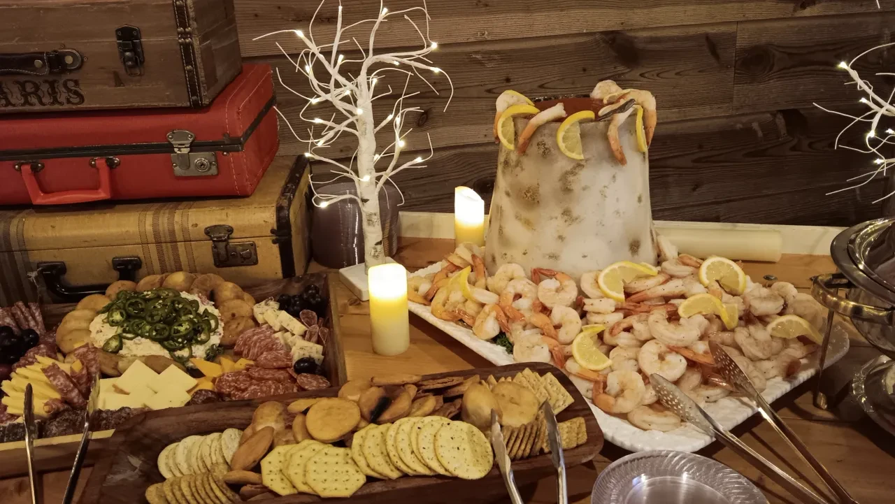 Rustic shrimp cocktail and charcuterie spread with candles